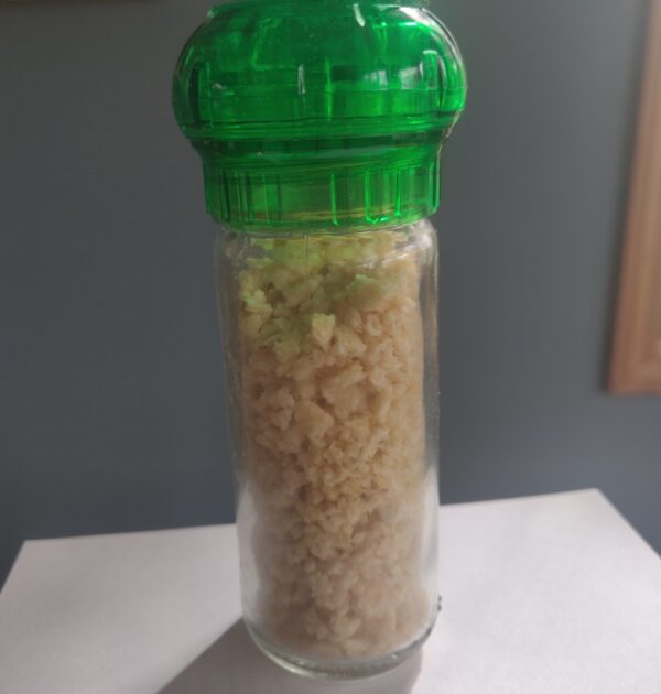 Garlic granules in refillable spice grinder.